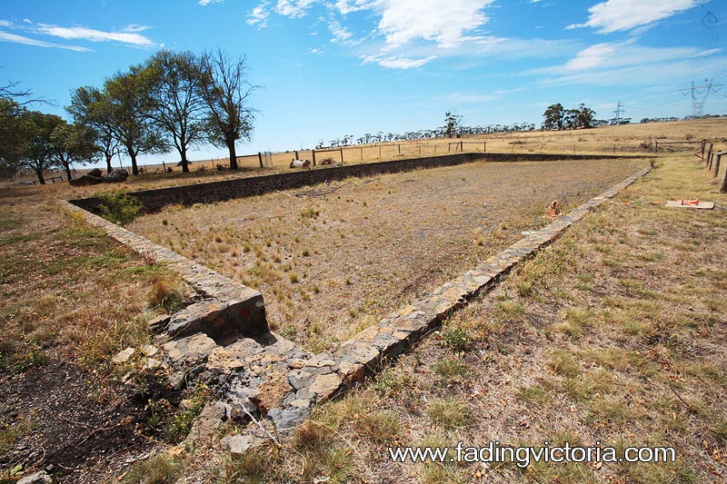 Appears to be the foundations and floor of a building; I couldn't find this on any of the plans or aerial photos over the years. Perhaps it was never completed?