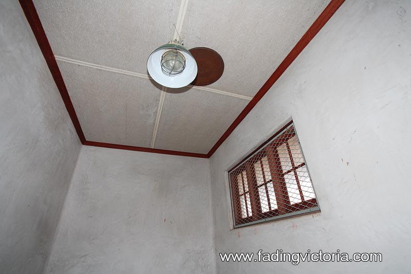 Interior of building. The walls are cladded with some kind of cement.