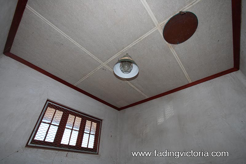 Interior of building. The circular disc on the ceiling appears to be a vent that can be opened or closed.