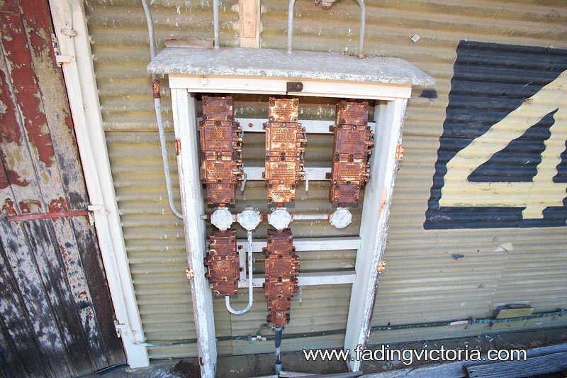 Electrical board outside warehouse 4. The doors are missing and the cover plates are rusted. They have probably not been maintained since about 1970 when the Greenvale Reservoir opened.